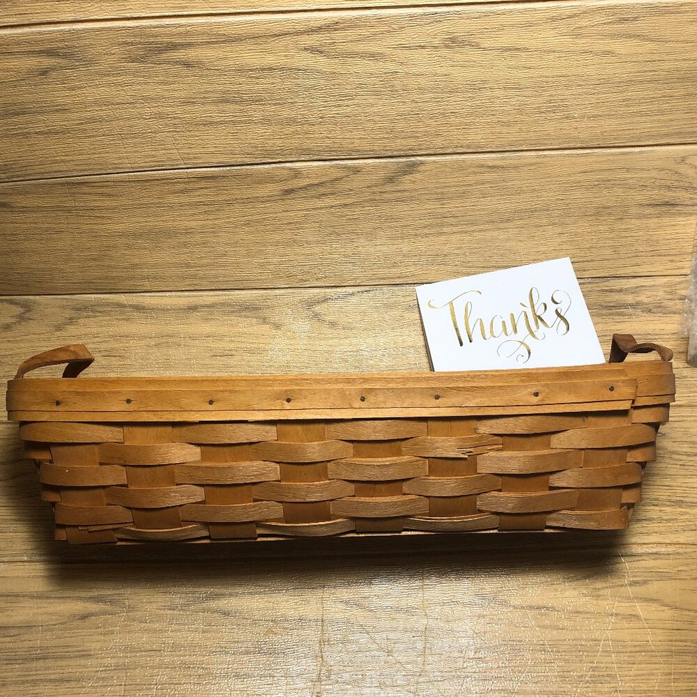 Longaberger long woven basket with leather handles, 1995